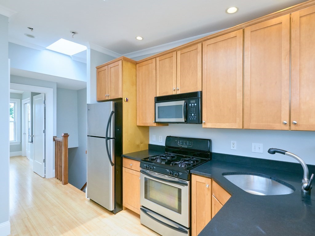 3 Leeds Street, Unit 3 Boston, MA 02127 - Photo 1 of 27 a kitchen with stainless steel appliances granite countertop a stove a refrigerator and a sink