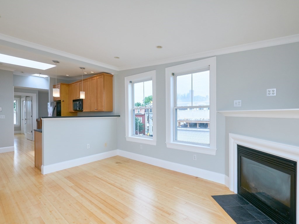 3 Leeds Street, Unit 3 Boston, MA 02127 - Photo 11 of 27 a view of a room with wooden floor and a fireplace
