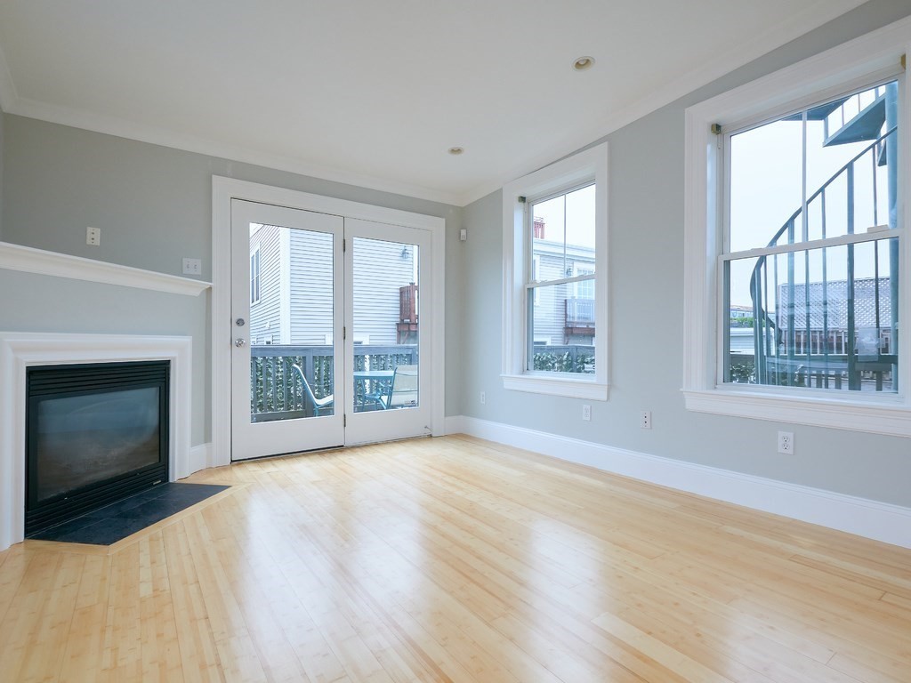 3 Leeds Street, Unit 3 Boston, MA 02127 - Photo 13 of 27 a view of an empty room with wooden floor and a window