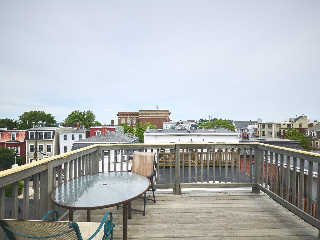 3 Leeds Street, Unit 3 Boston, MA 02127 - Photo 25 of 27 a view of a balcony with wooden floor and fence