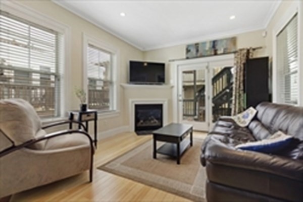 3 Leeds Street, Unit 3 Boston, MA 02127 - Photo 3 of 27 a living room with furniture and a fireplace