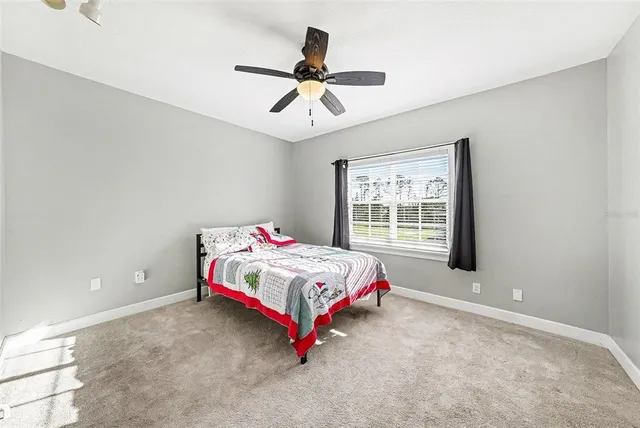 a bedroom with bed and a window