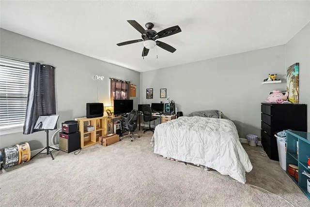 a bed room with furniture and flat screen tv