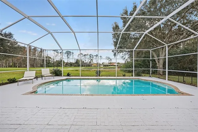 a view of a backyard with a swimming pool