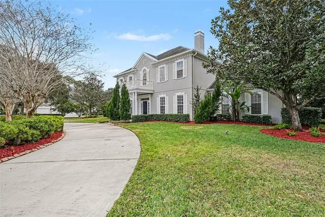 a front view of house with yard and green space
