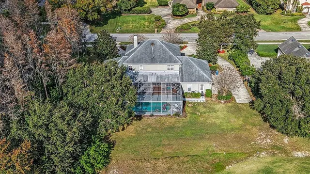 a view of a big yard with large trees