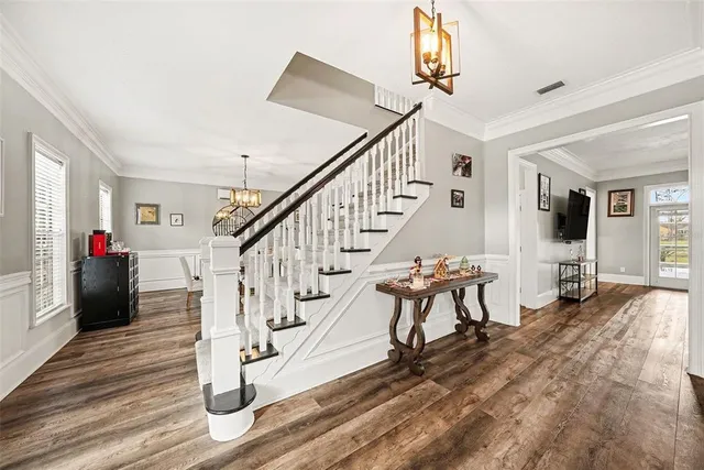 a view of entryway and hall with wooden floor
