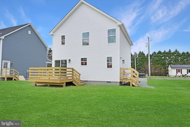 a front view of a house with garden and swing