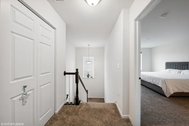 a view of a bedroom with a bed and a window