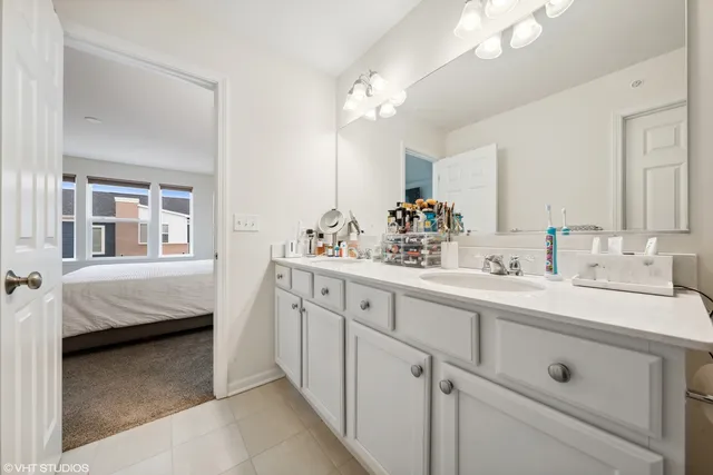 a en suite bathroom with double sink and a mirror