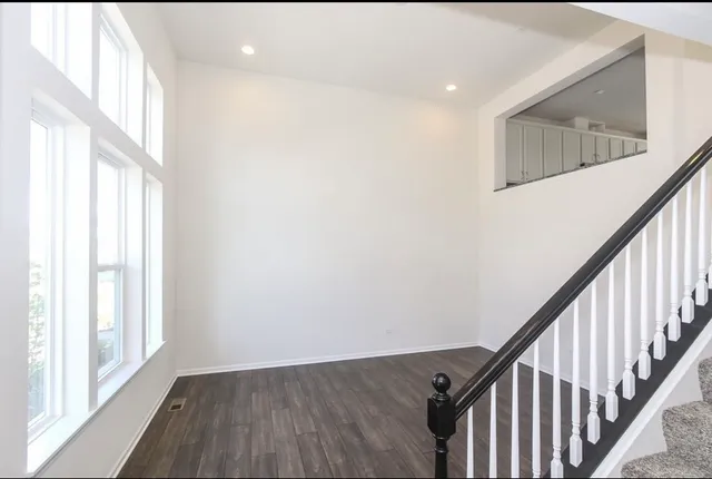 a view of an entryway with wooden floor