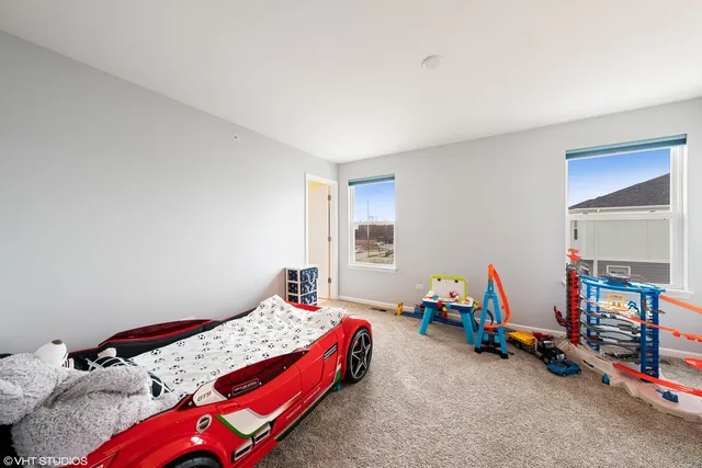 a bedroom with a bed and a wooden floor