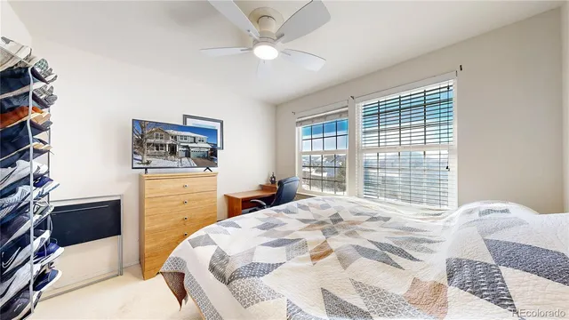 a view of an empty room with wooden floor and stairs