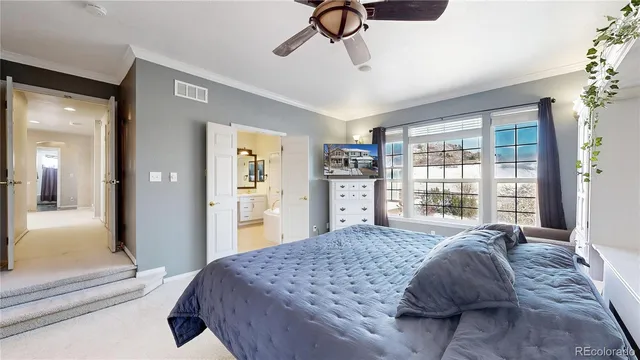 a large bedroom with a bed and a chandelier