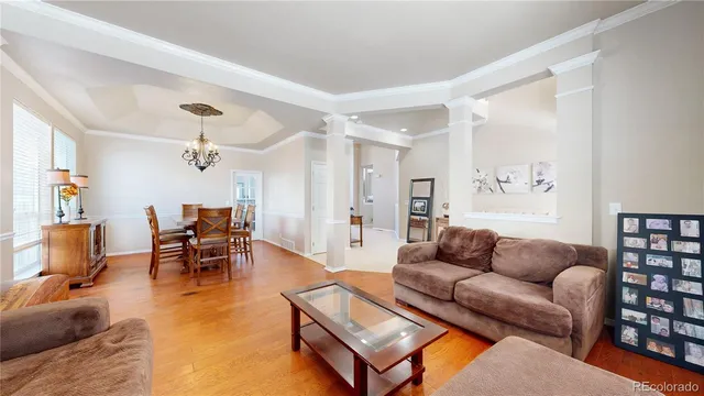 a living room with furniture a dining table and a piano table