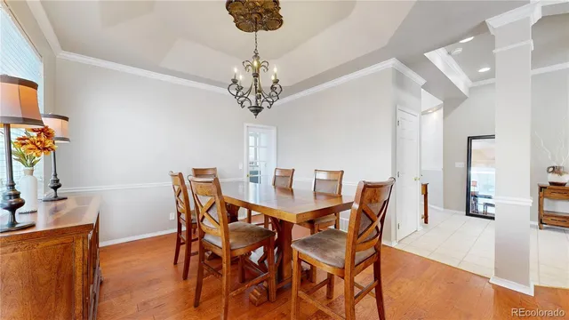 a view of a dining room with furniture and chandelier