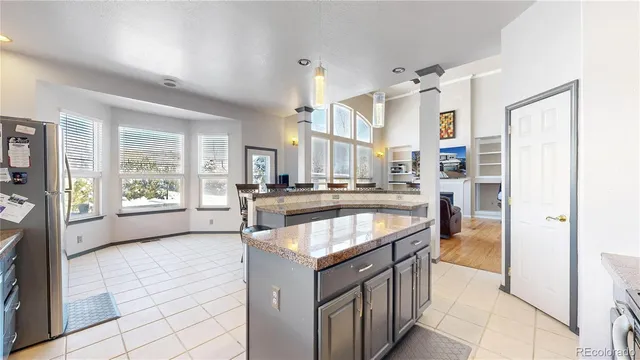 a kitchen with stainless steel appliances granite countertop a stove and a refrigerator