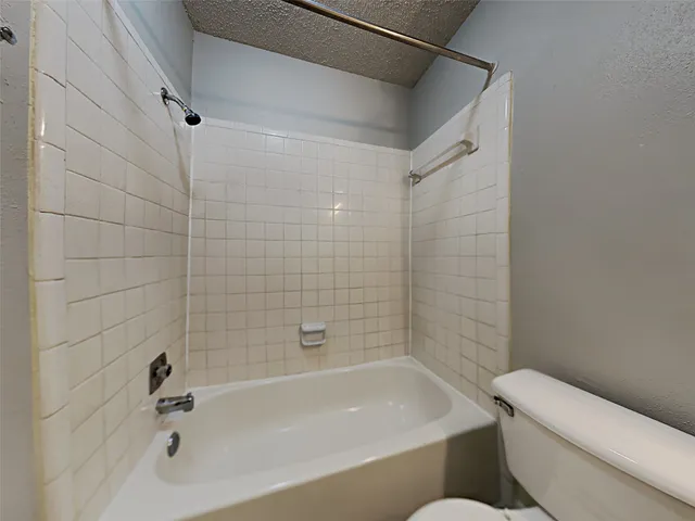 a bathroom with a bathtub and a toilet