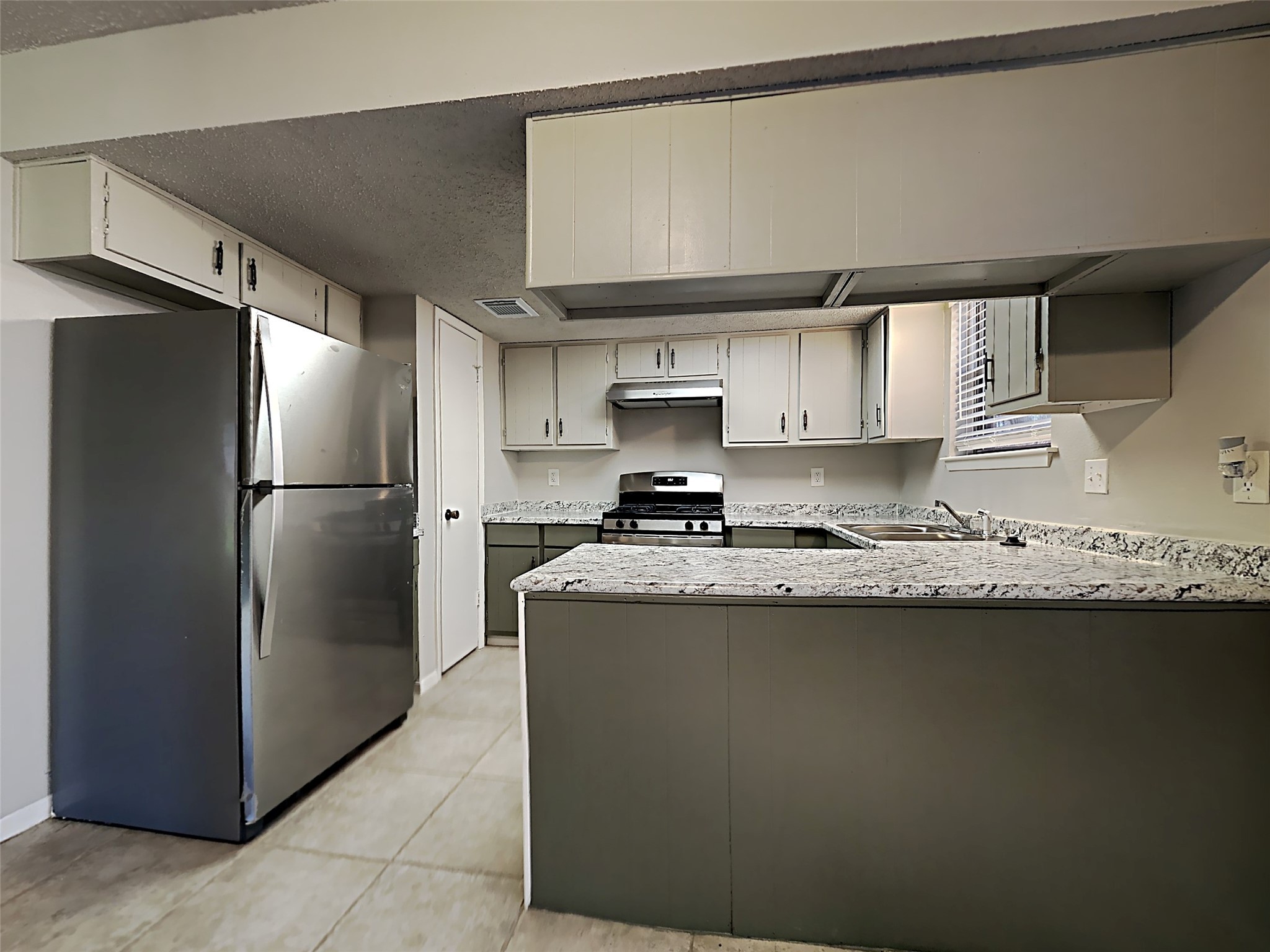23926 Spring Day Lane Spring, TX 77373 - Photo 2 of 19 a kitchen with stainless steel appliances granite countertop a refrigerator a sink and a stove