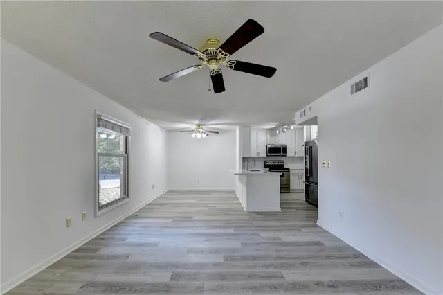 a view of a kitchen with a sink and a chandelier fan