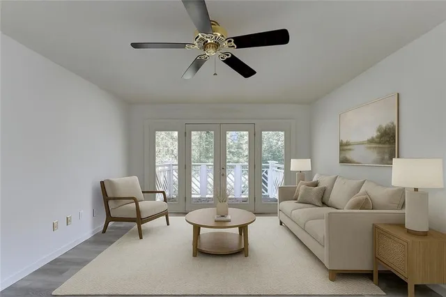 a living room with furniture kitchen view and a window
