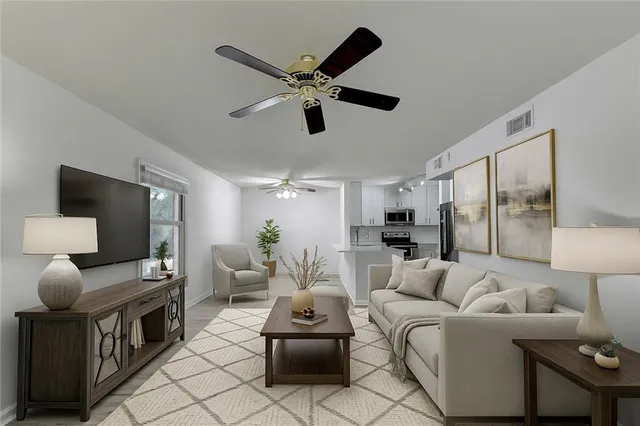 a kitchen with stainless steel appliances a refrigerator a sink a stove a dining table and chairs