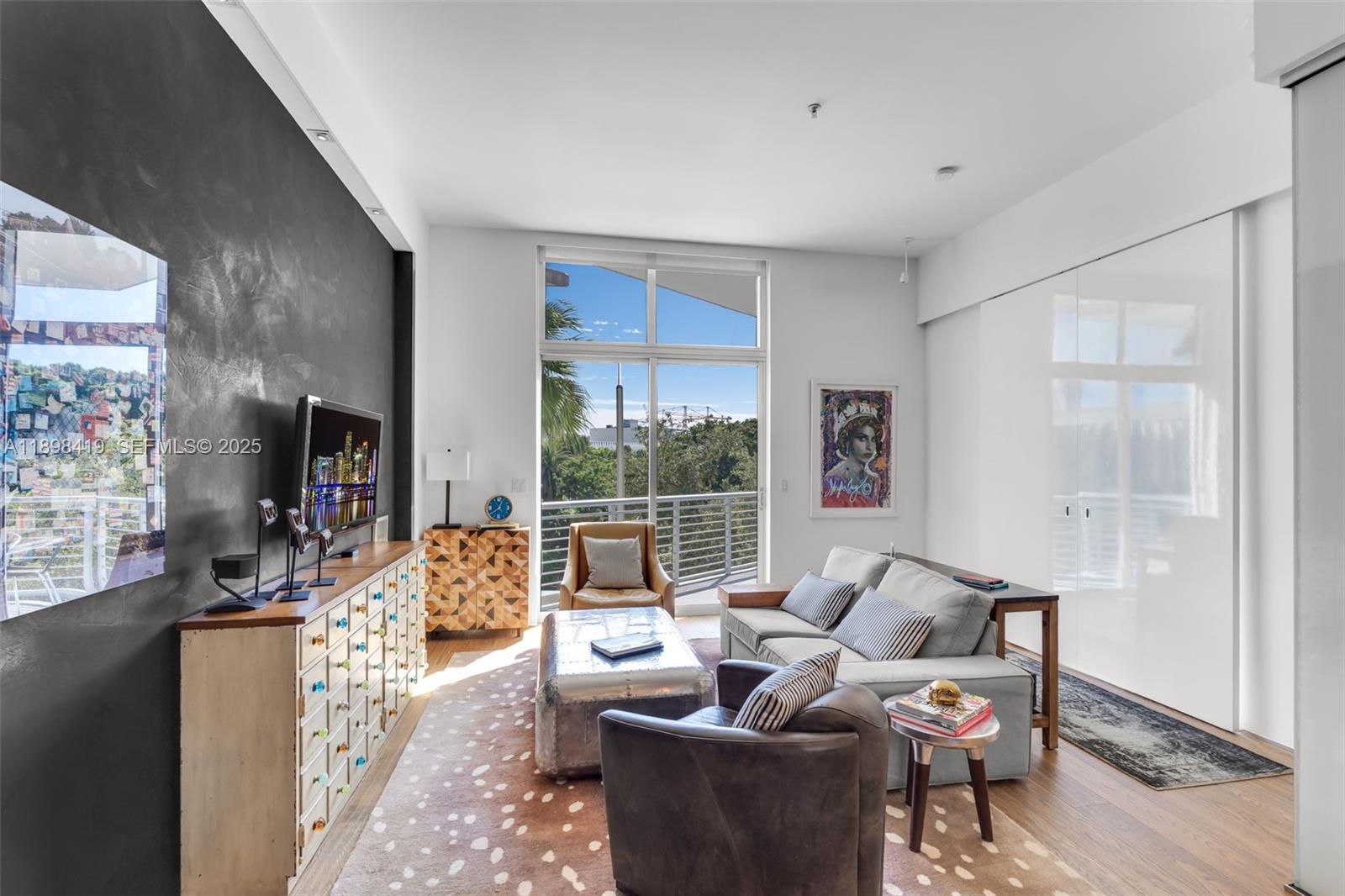 2001 Meridian Avenue, Unit 404 Miami Beach, FL 33139 - Photo 13 of 46 a living room with furniture and a flat screen tv