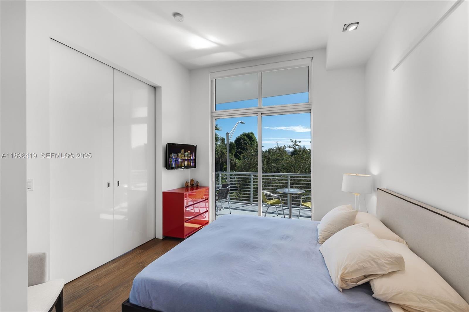 2001 Meridian Avenue, Unit 404 Miami Beach, FL 33139 - Photo 21 of 46 a bedroom with a bed and a window