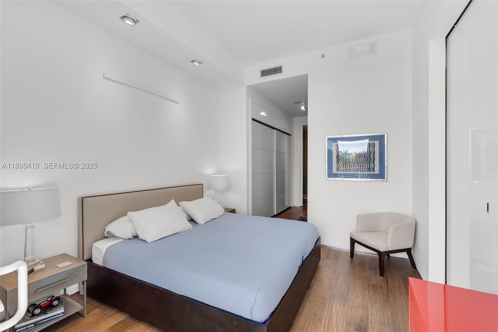 2001 Meridian Avenue, Unit 404 Miami Beach, FL 33139 - Photo 22 of 46 a bedroom with a bed and a table