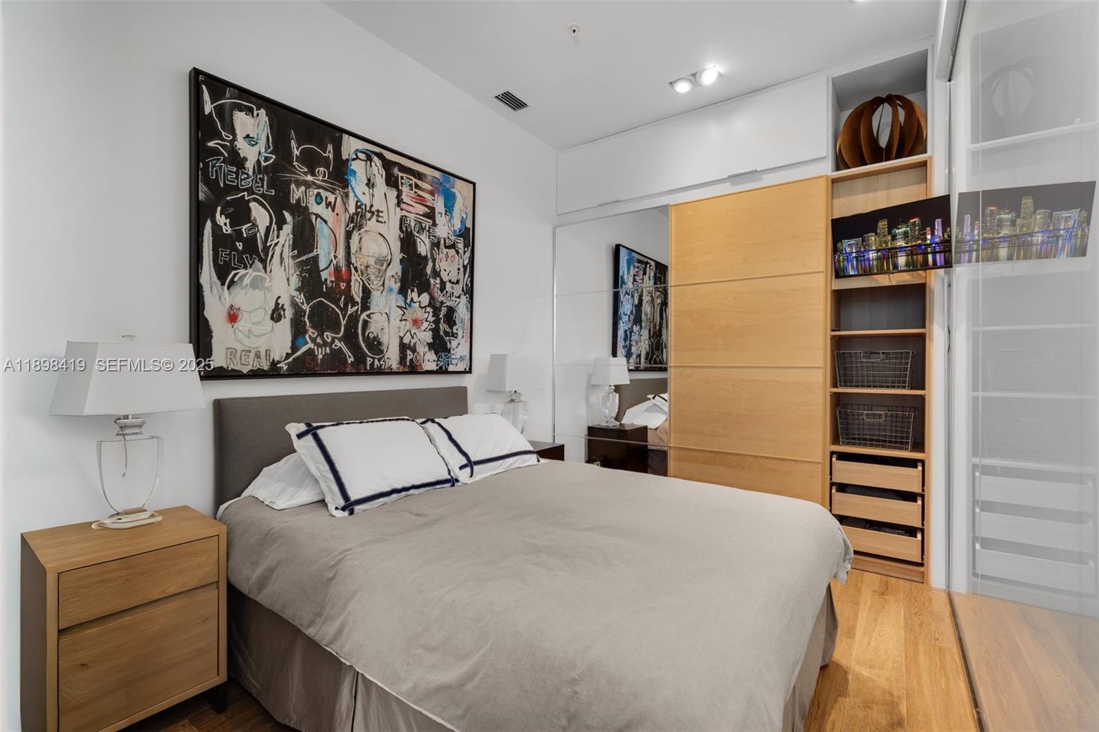 2001 Meridian Avenue, Unit 404 Miami Beach, FL 33139 - Photo 28 of 46 a bedroom with a bed and a painting on the wall