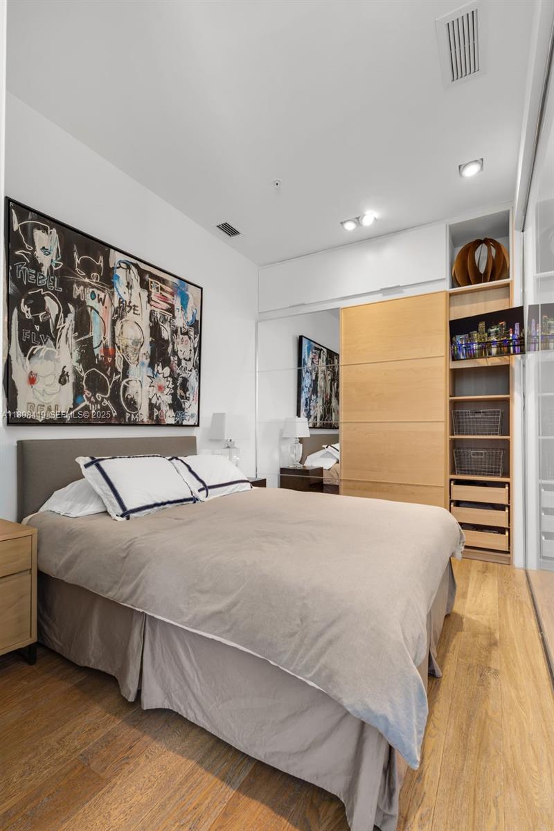 2001 Meridian Avenue, Unit 404 Miami Beach, FL 33139 - Photo 29 of 46 a bedroom with a bed and a painting on the wall
