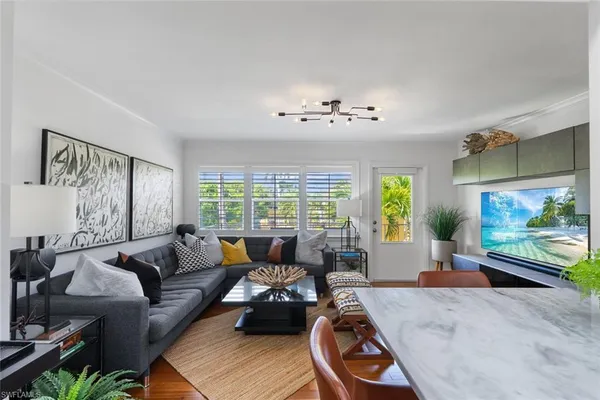 a living room with furniture and a flat screen tv