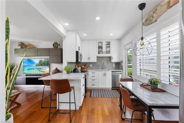 a living room with dining room and wooden floor