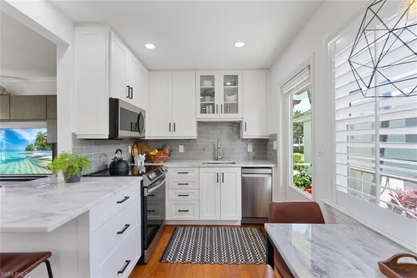 a kitchen with a sink stove and cabinets