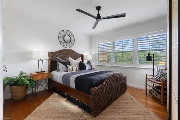 a bedroom with bed and balcony view
