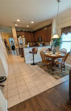 a kitchen with a sink a stove top oven and cabinetry
