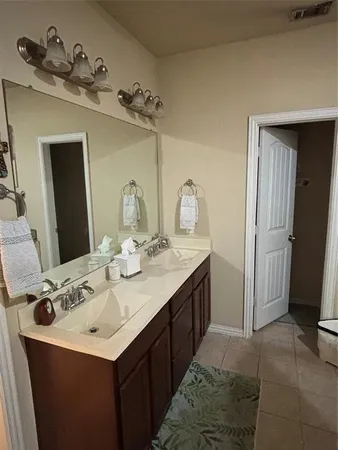 a bathroom with a sink vanity and a mirror