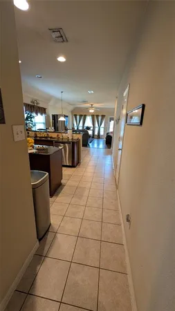 a living room with couches and kitchen view