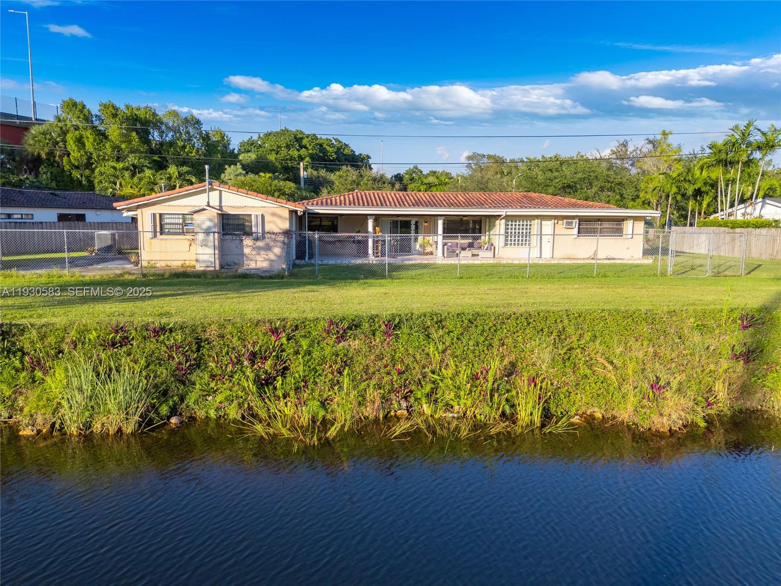 9380 Southwest 83rd Street Miami, FL 33173 - Photo 4 of 8 a front view of a house with a garden
