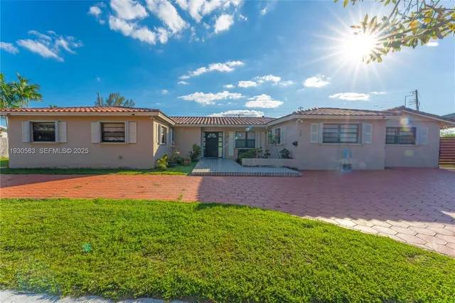 a front view of house with yard and green space