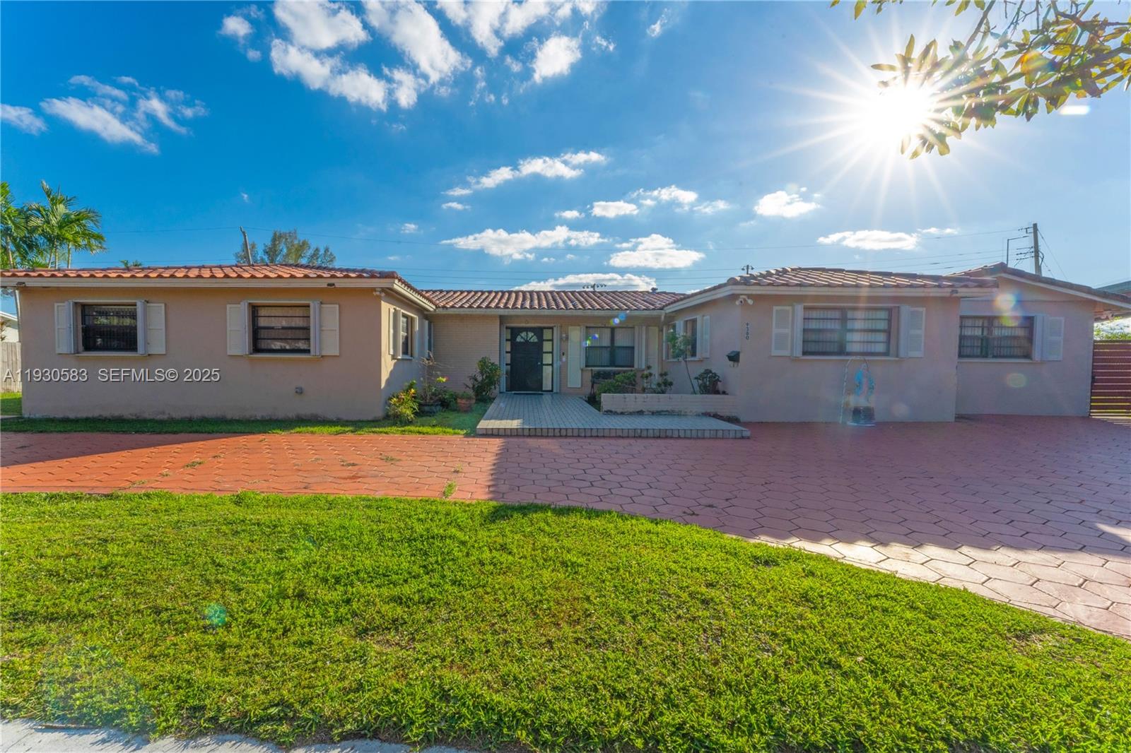 9380 Southwest 83rd Street Miami, FL 33173 - Photo 5 of 8 a front view of house with yard and green space
