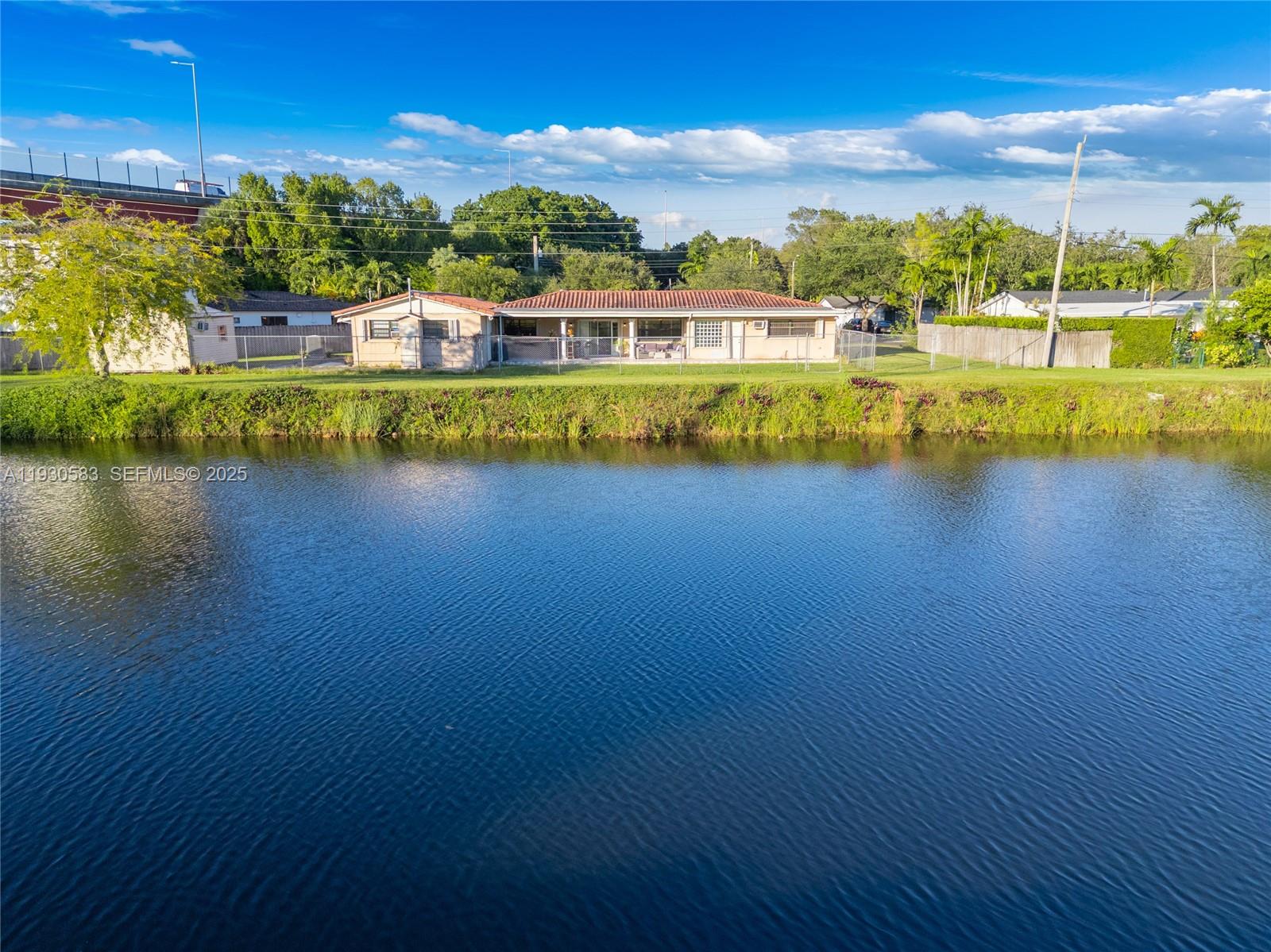 9380 Southwest 83rd Street Miami, FL 33173 - Photo 6 of 8 a view of a lake with houses in the back