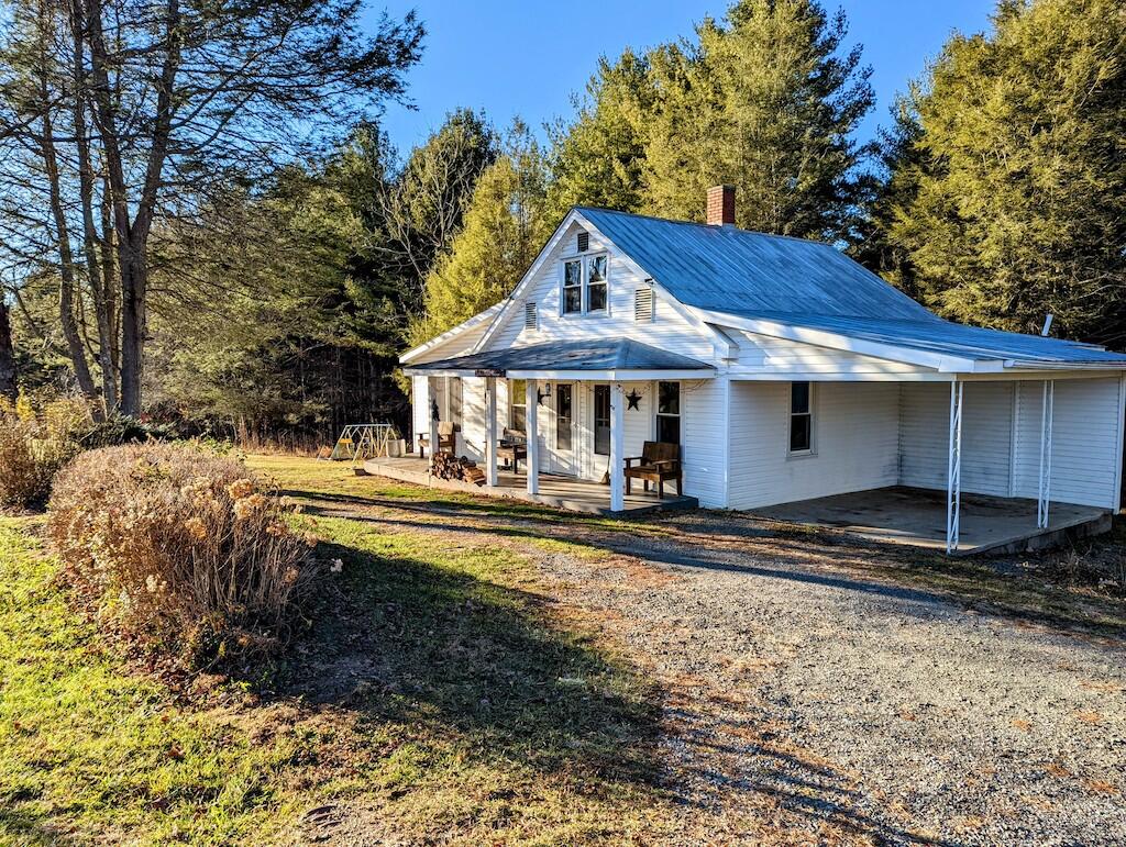 825 Macks Mountain Road Northwest Indian Valley, VA 24105 - Photo 3 of 30 a front view of a house with a yard table and chairs