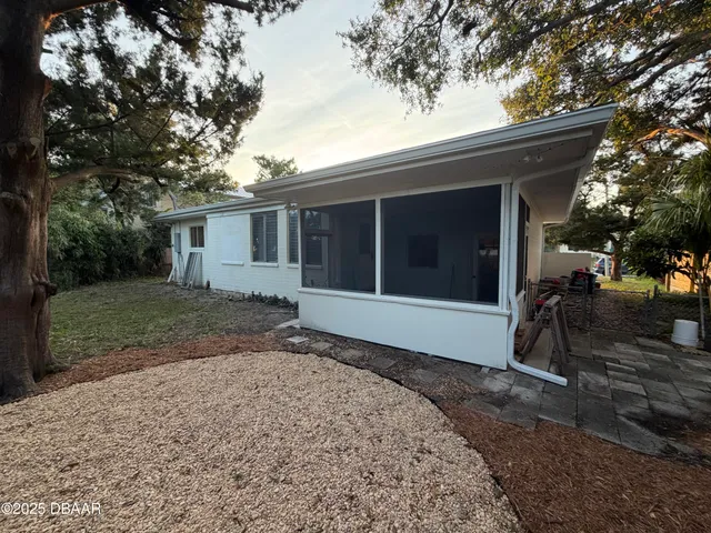 a view of a backyard with a large tree