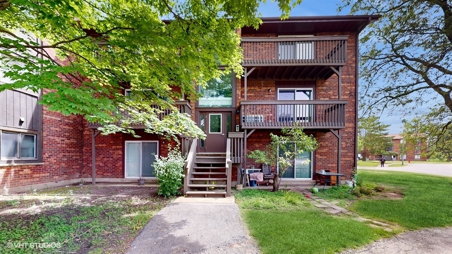 29-w542 Country Ridge Drive, Unit A Warrenville, IL 60555 - Photo 11 of 12 front view of house with a yard