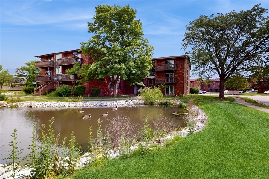 29-w542 Country Ridge Drive, Unit A Warrenville, IL 60555 - Photo 12 of 12 a view of a house with a yard