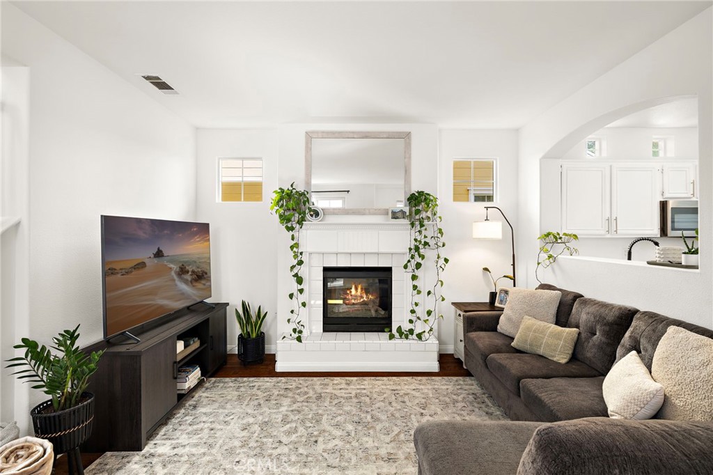 15 Honey Tree Ladera Ranch, CA 92694 - Photo 23 of 51 a living room with furniture a flat screen tv and a fireplace