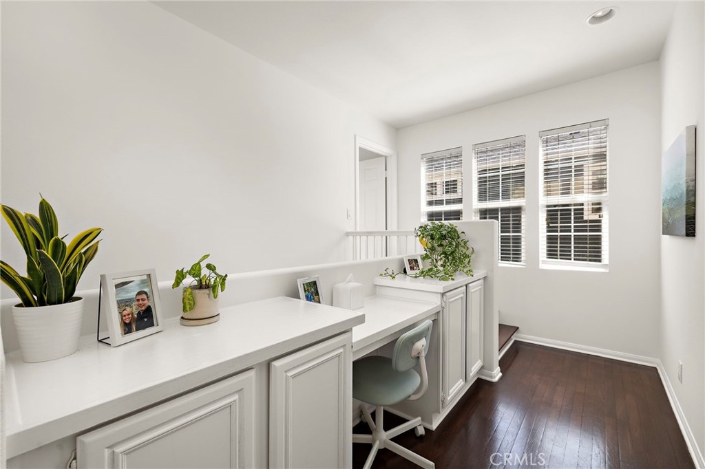 15 Honey Tree Ladera Ranch, CA 92694 - Photo 32 of 51 a kitchen with a potted plant on the counter and a wooden floor