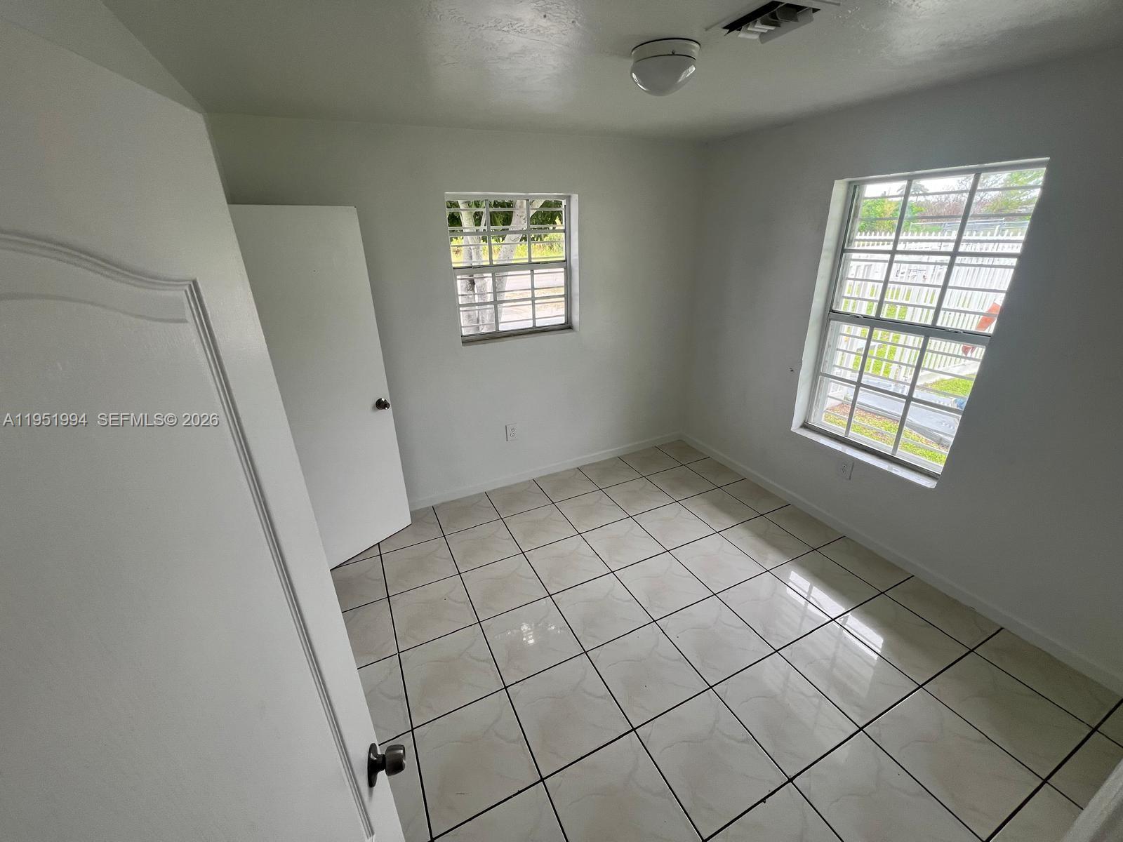 11535 Southwest 224th Street, Unit 2 Miami, FL 33170 - Photo 11 of 22 a view of an empty room and window