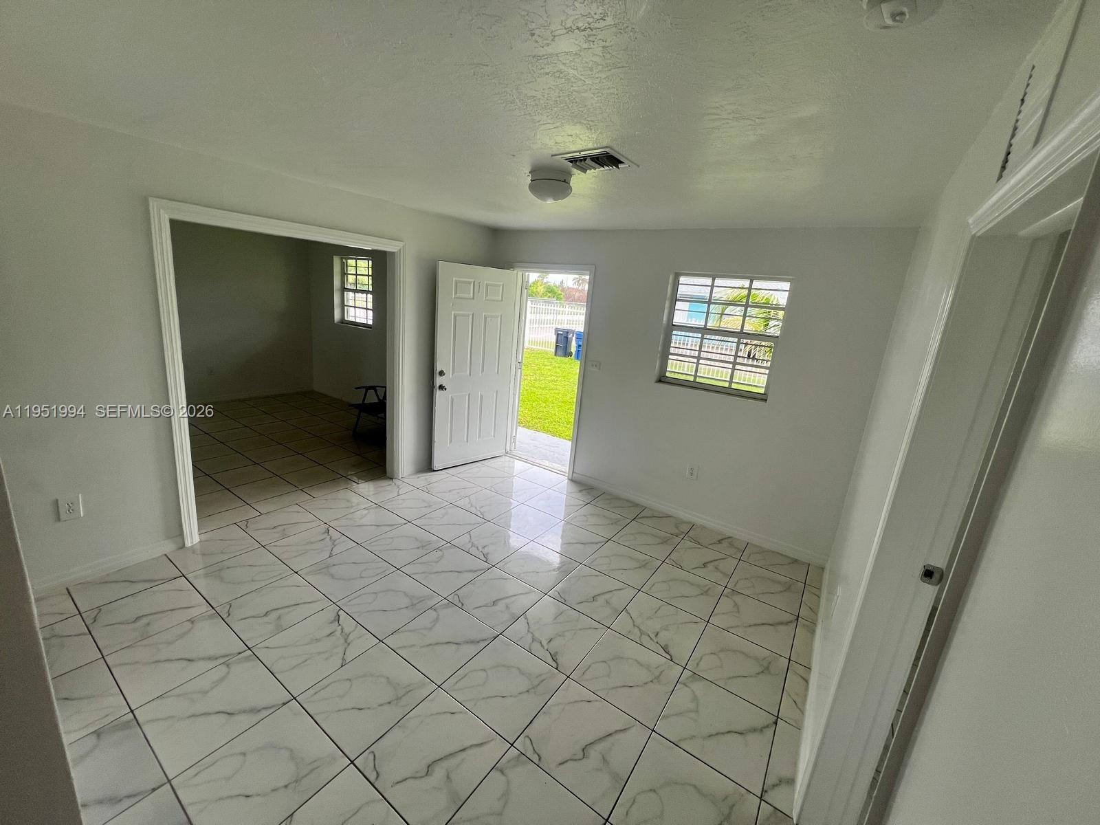 11535 Southwest 224th Street, Unit 2 Miami, FL 33170 - Photo 14 of 22 a view of an empty room with a window